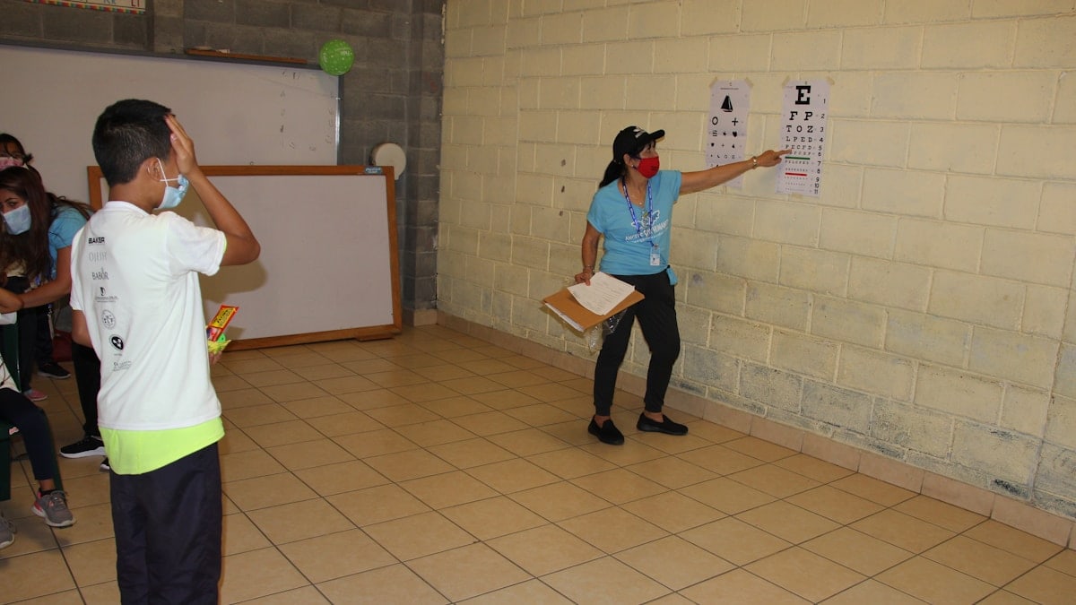a group of people standing around a room